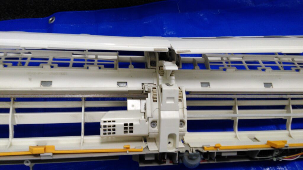 お掃除機能付きエアコンをプロが分解して洗浄している作業中の写真
